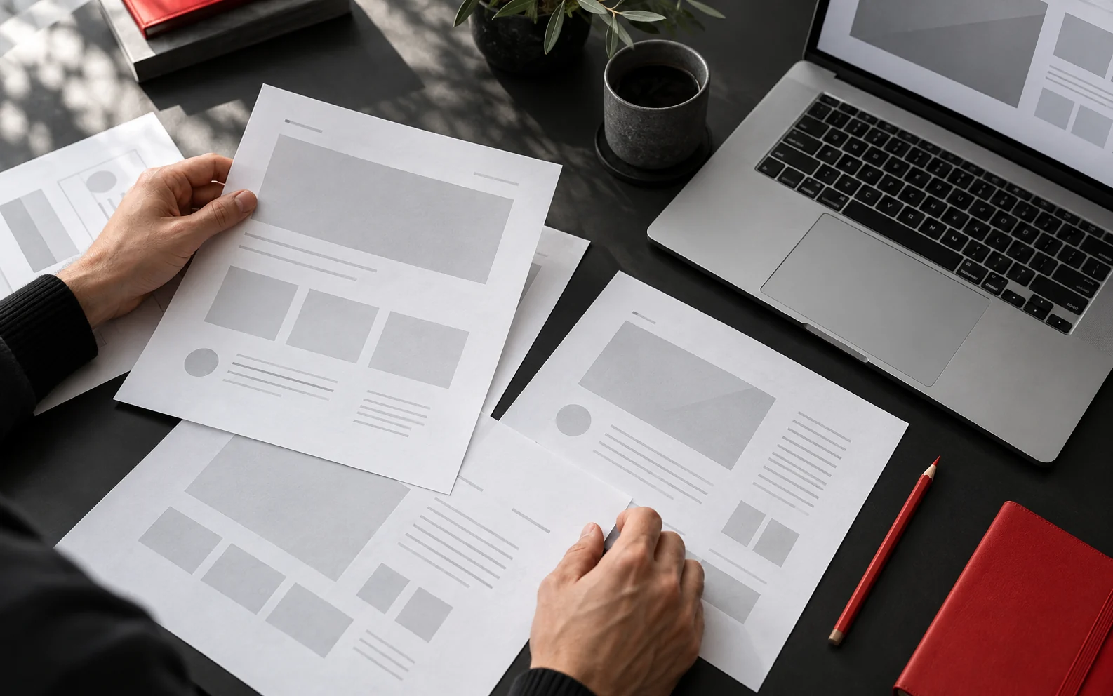 Creative planning with website wireframes and a laptop.